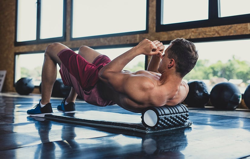 man drinking water at gym